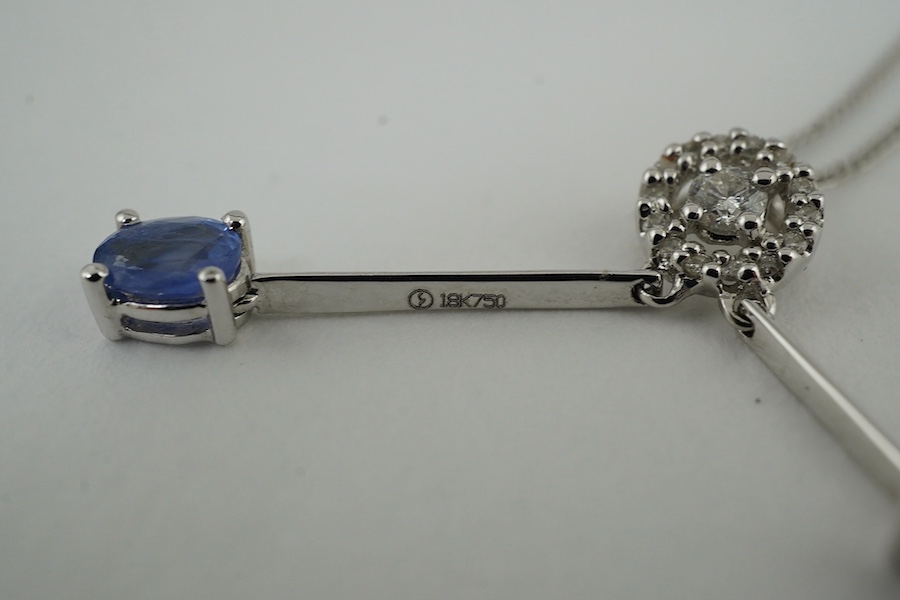 A modern 18k, two colour sapphire and diamond set double drop pendant, 26mm, on a 9ct white gold chain, 38cm, gross weight 2.5 grams. Condition - good